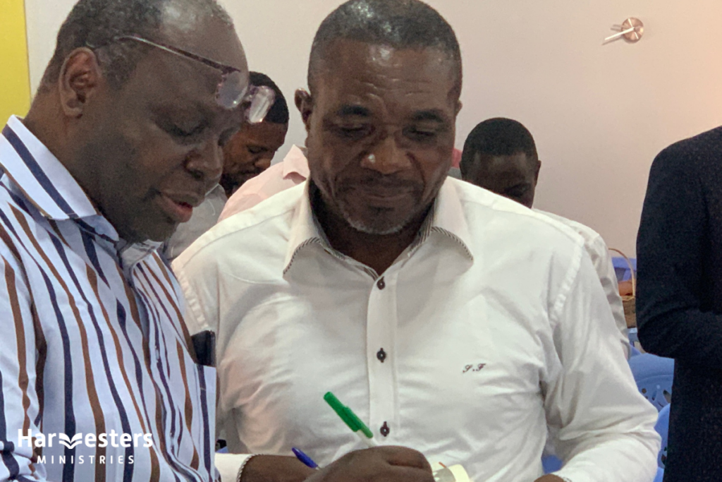 Taking notes. Harvesters Ministries