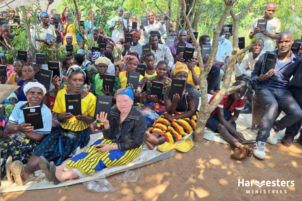 Gloria and her church with Bibles.