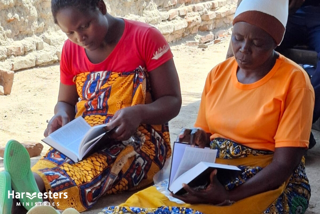 Ladies looking at new Bibles. Harvesters Ministries
