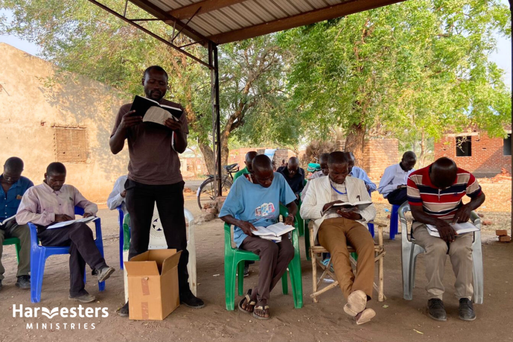 Reading from new Bible. Harvesters Ministries