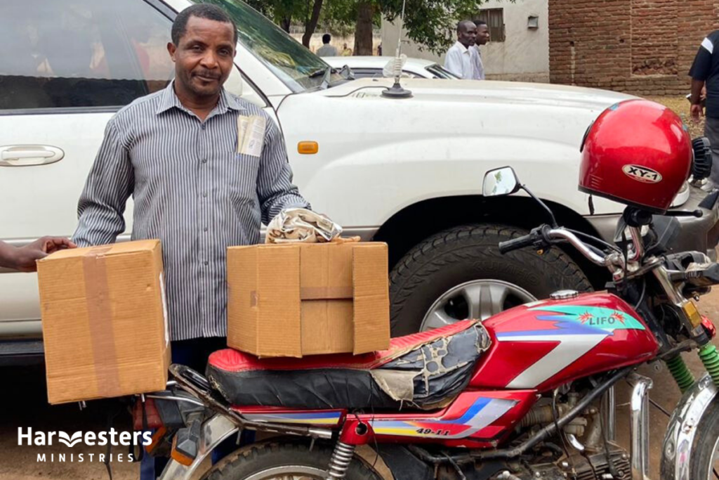 Taking boxes of Bibles to more churches. Harvesters Ministries